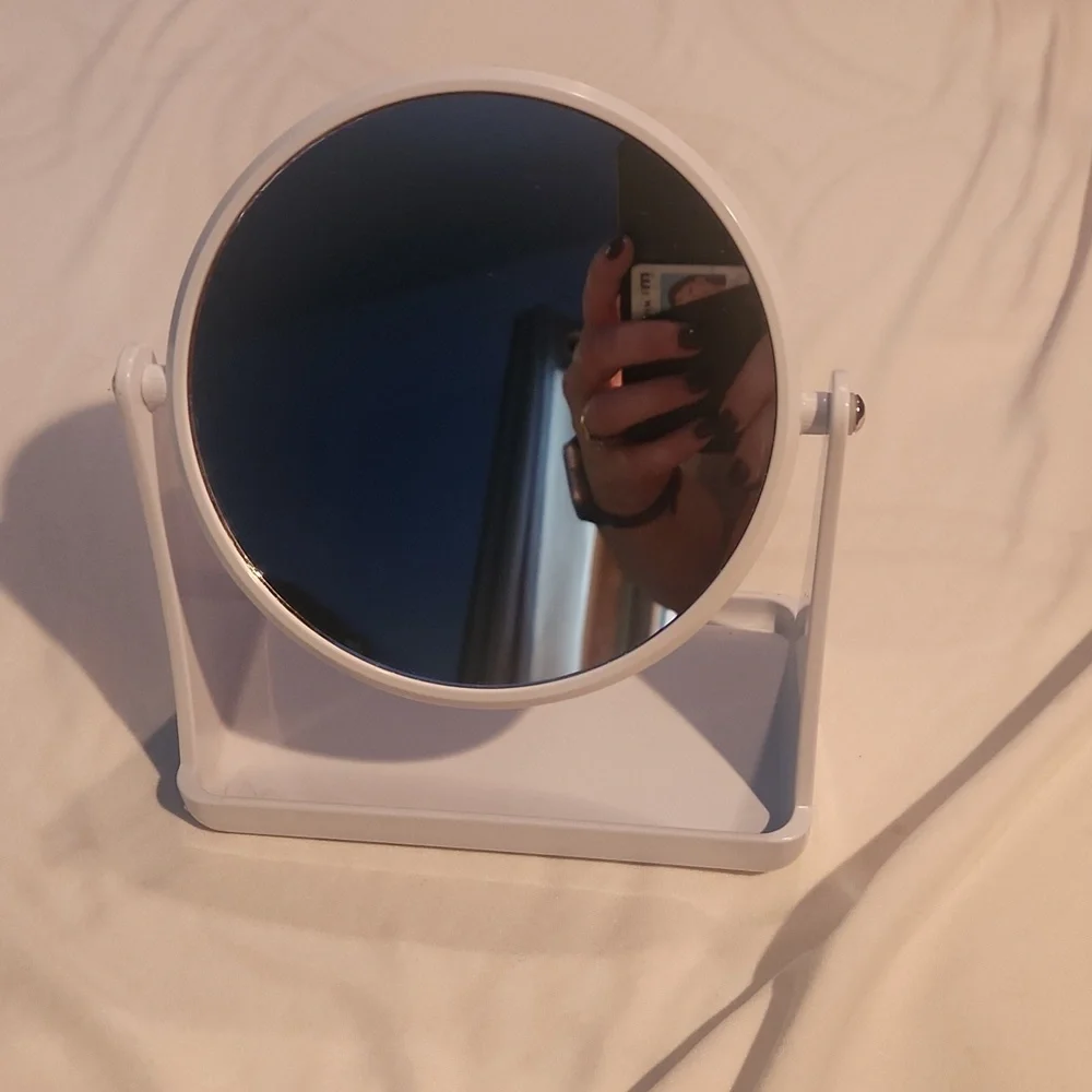 White double-sided vanity mirror with one side magnified.